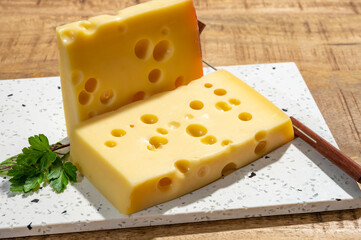 Cheese collection, blocks of French emmentaler cheese with many round holes made from cow milk