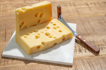 Cheese collection, blocks of French emmentaler cheese with many round holes made from cow milk