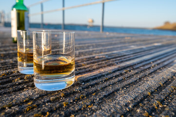 Drinking single malt Scotch whisky at sunset with sea, ocean or river view, private whisky tours in Scotland, UK