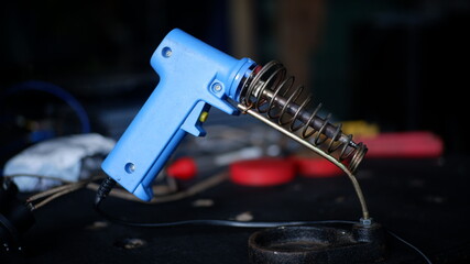 Soldering iron   solder on  deep bokeh background