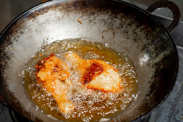 Fry the chicken in a pan with boiling oil.