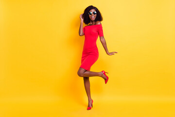 Obraz na płótnie Canvas Full length phot of young excited afro girl happy positive smile look stunning isolated over yellow color background