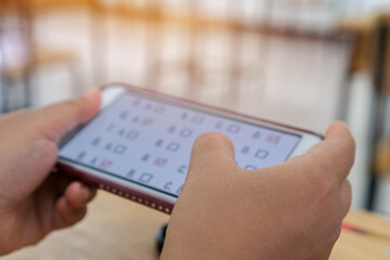 Exam Online from home. Student testing exams answer on multiple choice questions by finger clicking in Digital Smartphone. Concept learning technologies when lockdown quarantine COVID-19 outbreak