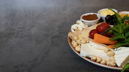 Gourmet chees breakfast plate idea, breakfast appetizer plate with gray marble background