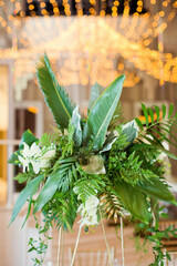 Exotic flower composition with palm leaves