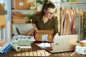 Foto op Plexiglas stylish small business owner woman using laptop in office © Alliance
