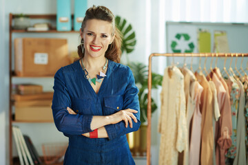 smiling business owner woman in office in blue overall