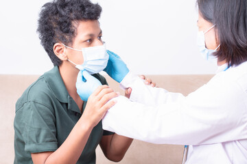 Medical care, Woman doctor wearing face mask taking care patient, Female doctor comfort  young boy patient, Business medical health care, Female wearing protection mask take care teenager man patient