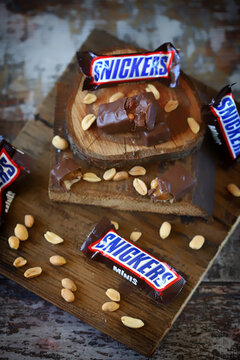 Kharkiv Ukraine June 08 2020 Mini Snickers and peanuts on wooden surface. Snickers advertising.