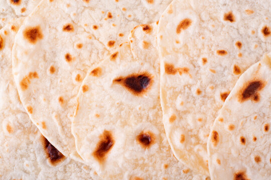 Tortilla flatbreads overlaping. Full frame background. Mexican food