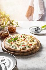 Hot melting cheese pizza. Italian traditional food on a light concrete background.