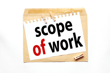 SCOPE OF WORK. text on white paper on craft notebook