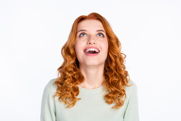 Photo portrait of red haired young girl looking up amazed with opened mouth isolated on white color background