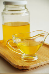 Freshly made liquid homemade ghee butter oil. Healthy food concept. Ayurveda product