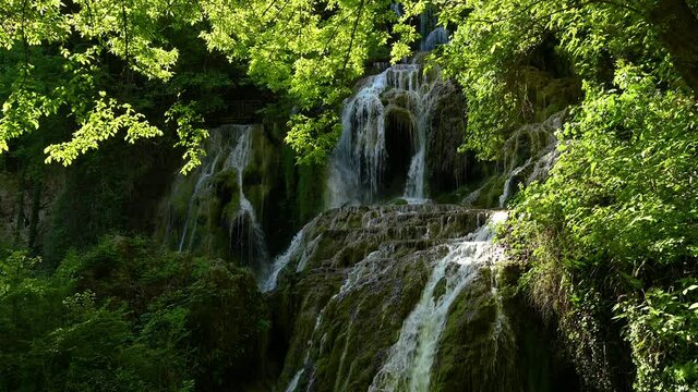 Video with a beautiful waterfall in green spring forest, Krushuna falls, Balkan Mountains, Bulgaria..
