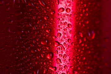 Water droplets on red metallic can