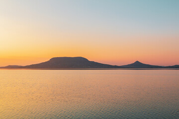 Beautiful panorama of Lake Balaton near the town of Fonyod, in the background the Badacsony Mountains and Szigliget at sunset - 436883337
