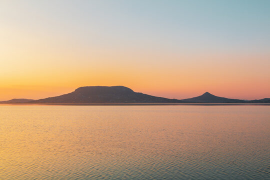 Beautiful panorama of Lake Balaton near the town of Fonyod, in the background the Badacsony Mountains and Szigliget at sunset