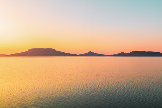 Beautiful panorama of Lake Balaton near the town of Fonyod, in the background the Badacsony Mountains and Szigliget at sunset