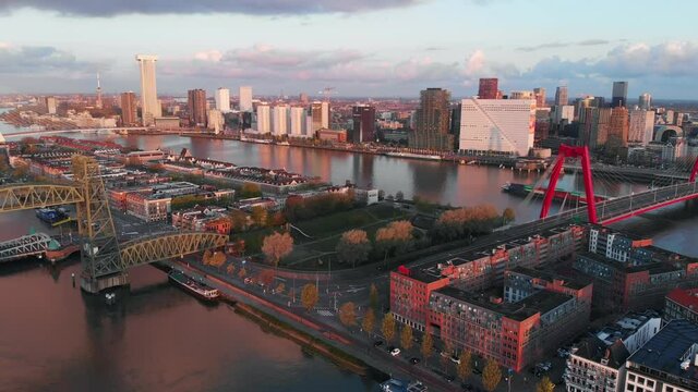 Beautiful drone video of the skyline of Rotterdam during sunrise. Bridges connecting the different sides of the city.