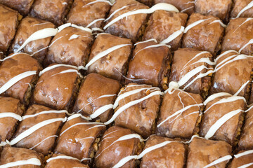 Full frame of rectangle-shaped nut and chocolate baklava on a tray