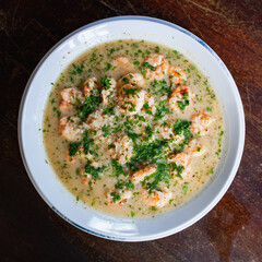 shrimp soup on plate with toast entrée