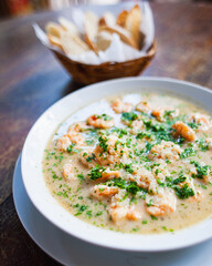 shrimp soup on plate with toast entrée