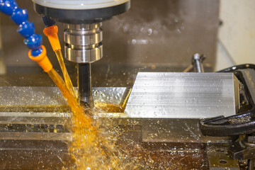 The CNC milling machine cutting the  tire mold parts with oil coolant method. The mold and die manufacturing process by CNC machining center.