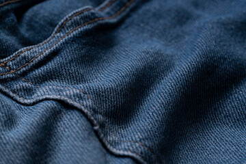 Fototapeta premium Blue jeans apparel and brown cord fabric background texture, cloth garment concept, close up view.