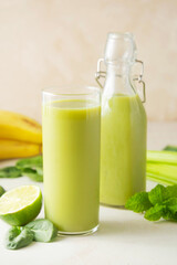 Detox drink. Green smoothie glass with fresh fruits and spinach. Healthy eating.