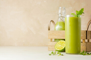 Fresh homemade green smoothie detox drink with spinach, cucumber, lime, bananas.