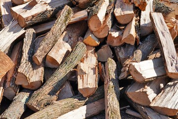 Stacks of chopped fire wood logs outside for sale