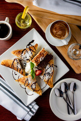 Italian Dessert platter. Cheesecake, très lèches, tiramisu apple tarts, and chocolate cake slices topped with whipped cream and raspberry sauce. Classic Italian restaurant dessert favorites.