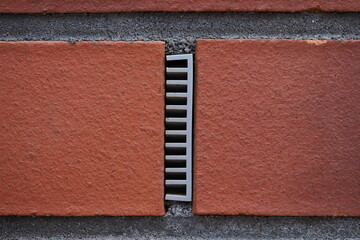 ventilation plastic insert in a brick wall