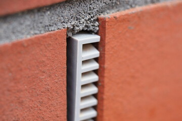 ventilation plastic insert in a brick wall