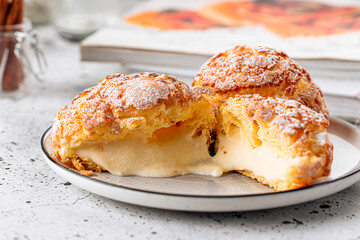 Fresh baked choux pastry cakes with cream filling