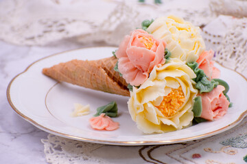 Beautiful piped buttercream flowers in cone cupcakes on stylish table
