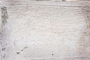.Plastered wall of an old house with traces of weathering. Uneven gray surface. Grunge. Texture. Background. Copy space.