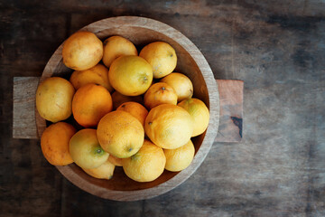 Image of group of fresh lemons over old vintage wooden table