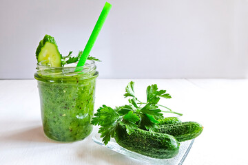 Green cocktail of spinach, lemon, cucumber and parsley on a light background. The concept of healthy nutrition, detox, green, diet, vegan, keto, fit