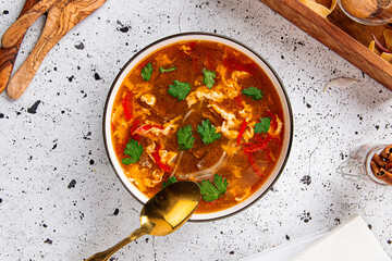 Bowl of spicy beef soup on a light decorated background