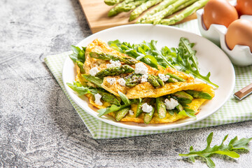 Gourmet Tasty Egg Omelette with Asparagus and soft Cheese. Asparagus. Fresh Asparagus with eggs