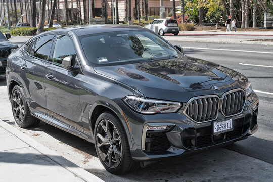 Long Beach, California USA - April 11, 2021: black bmw x6m competition luxury car. left side view