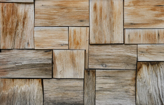 Patchwork of raw brown and gray wood forming a parquet wood pattern. Wood wall pattern. Old wooden wall. © VLADISLAV
