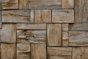 Patchwork of raw wood forming a parquet wood pattern. Wood wall pattern. Old wooden wall.