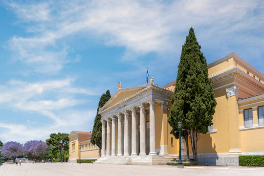 Athens, Attica, Greec. Zappeion Hall is a neoclassical building in the National Garden park near Syntagma Square in the center of Athens. Angled panoramic view, sunny day, cloudy sky
