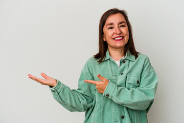 Middle age caucasian woman isolated on white background excited holding a copy space on palm.