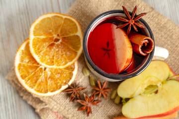 Mulled wine in white mug with fruit and spices