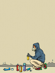 a teenage boy draws graffiti. street art. aerosol paints © studiostoks