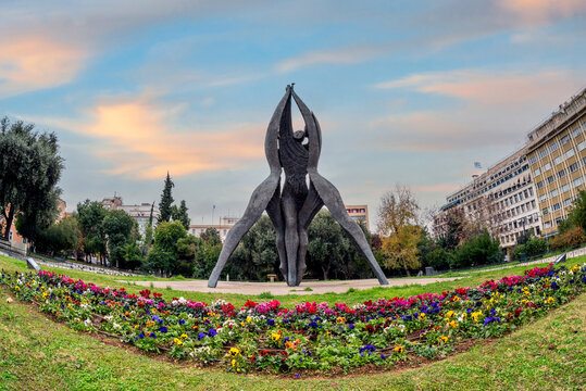 Athens, Attica, Greece. Monument of National Reconciliation sculpture at Klathmonos square. The 8 meter figures embrace one another with one hand and the other rises to the sky. Sunset